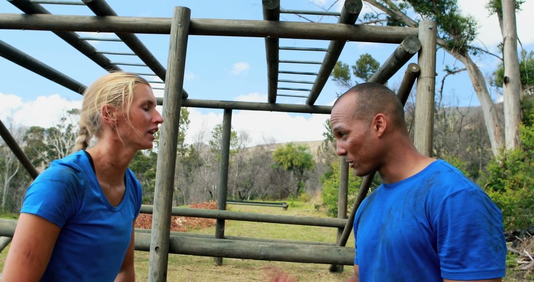 Exhausted Athletes Discussing During Obstacle Course Training - Free Images, Stock Photos and Pictures on Pikwizard.com