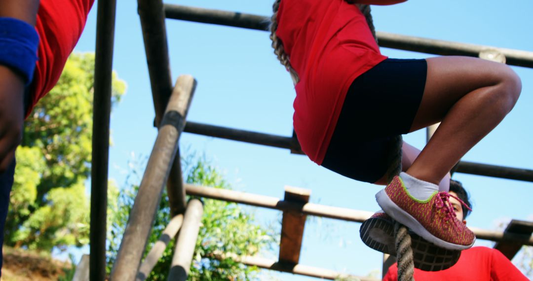 Participants Climbing Rope in Outdoor Obstacle Course - Free Images, Stock Photos and Pictures on Pikwizard.com