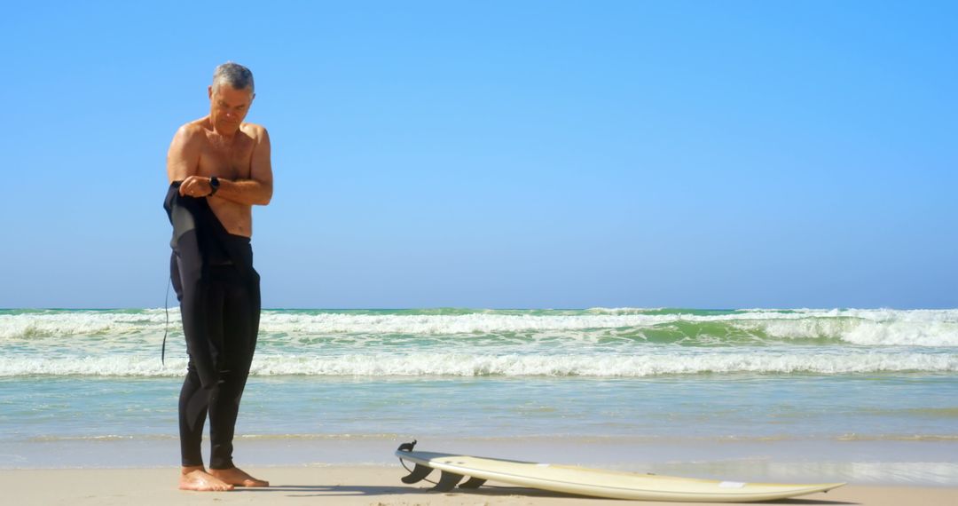 Senior Surfer Preparing for Waves on Sunny Beach Day