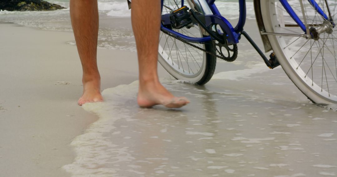 Man Walking Bicycle on Idyllic Sandy Beach