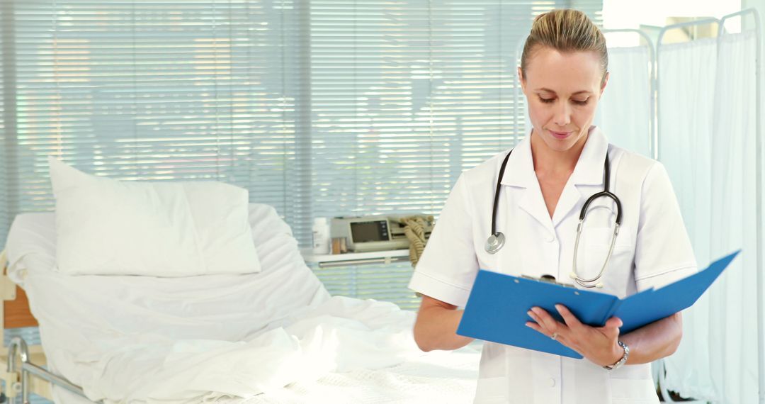 Nurse Reviewing Patient Chart in Hospital Room - Free Images, Stock Photos and Pictures on Pikwizard.com