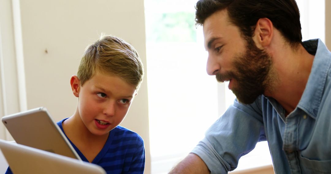 Father Helping Young Son with Homework on Tablet - Free Images, Stock Photos and Pictures on Pikwizard.com