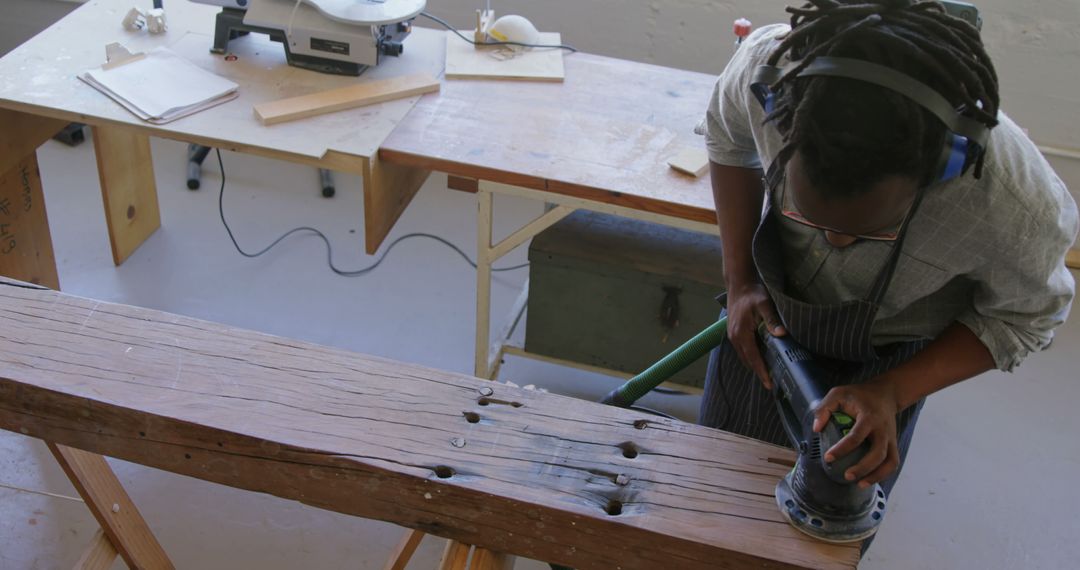 Woodworker Polishing Wooden Beam in Workshop - Free Images, Stock Photos and Pictures on Pikwizard.com