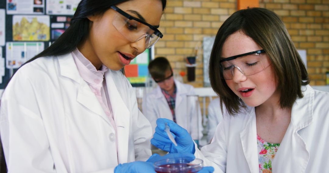 Diverse Female Students Conducting Science Experiment in Laboratory - Free Images, Stock Photos and Pictures on Pikwizard.com