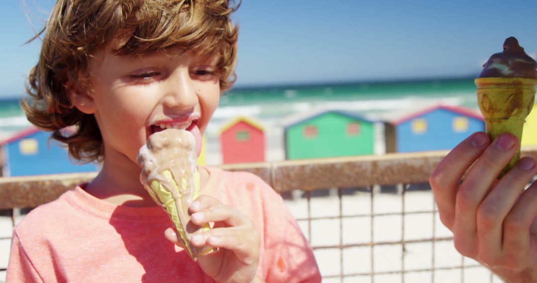 Joyful Child Eating Ice Cream at the Beach with Colorful Background - Free Images, Stock Photos and Pictures on Pikwizard.com