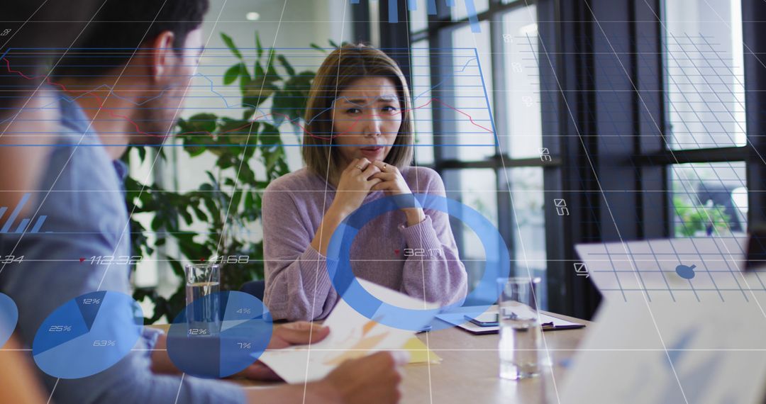 Business team analyzing data during office meeting with futuristic interface overlay - Free Images, Stock Photos and Pictures on Pikwizard.com