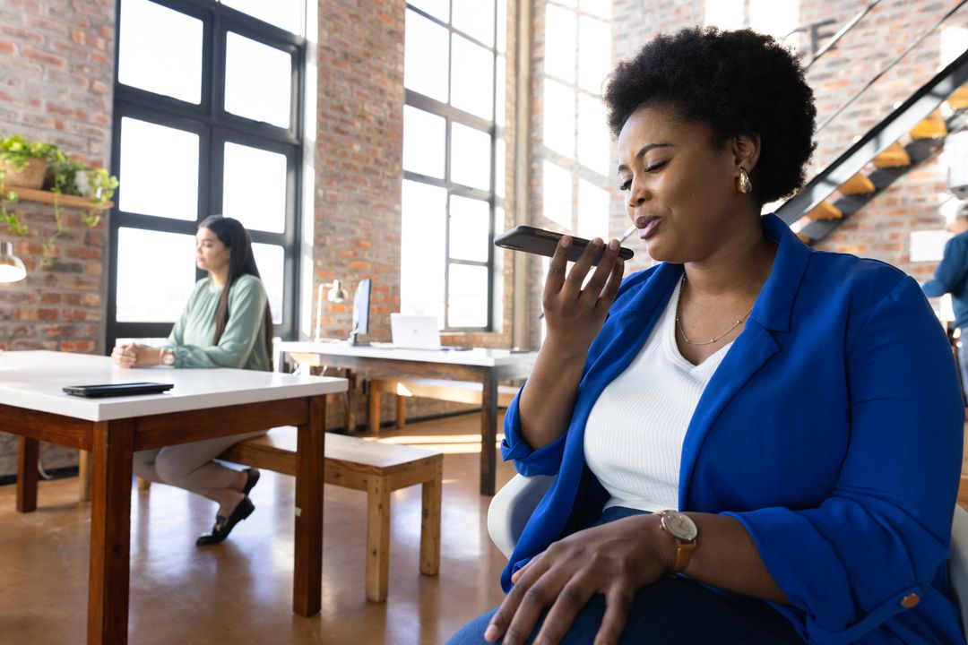 Professional Women Using Technology in Loft Office Environment