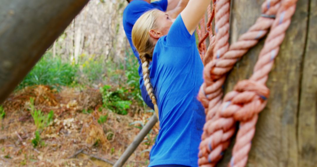 Woman Climbing Rope on Outdoor Obstacle Course in Forest - Free Images, Stock Photos and Pictures on Pikwizard.com