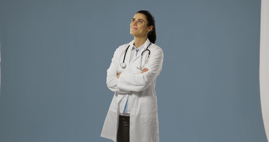 Confident Female Doctor with Stethoscope Looking Up - Free Images, Stock Photos and Pictures on Pikwizard.com