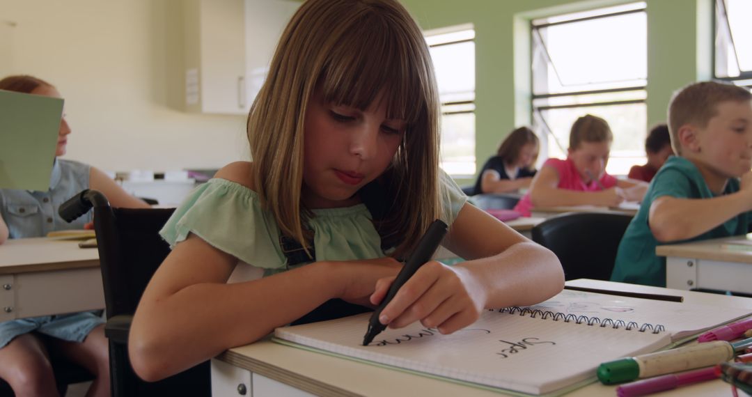 Focused Schoolgirl Writing in Classroom with Classmates - Free Images, Stock Photos and Pictures on Pikwizard.com