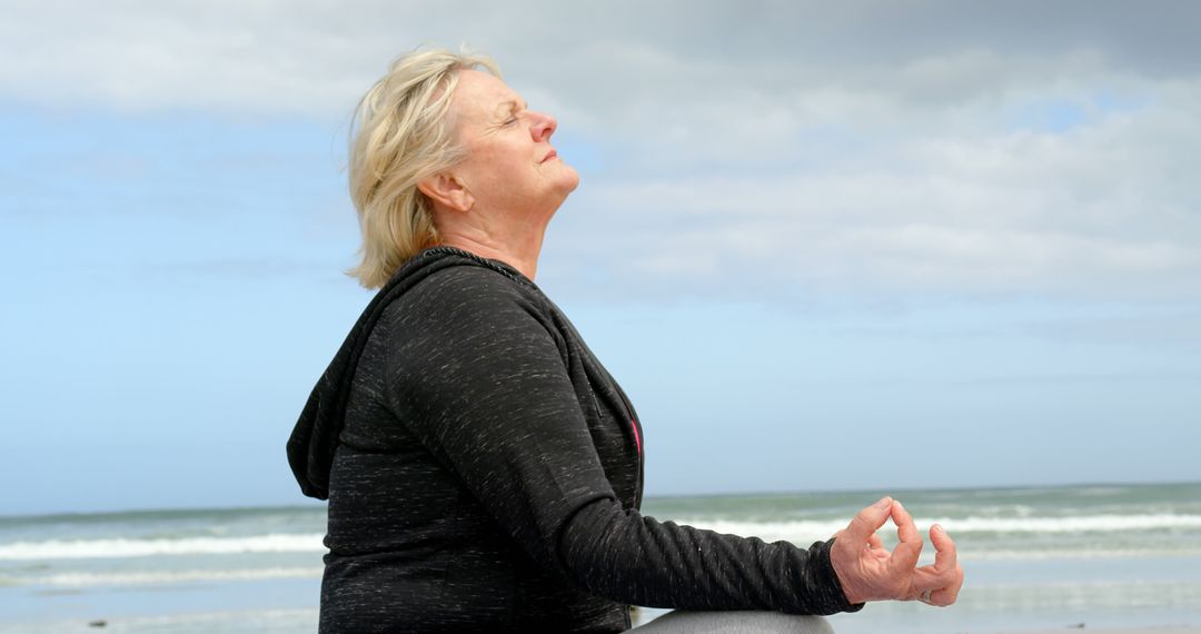 Senior Woman Meditating on Beach Practicing Mindfulness Yoga - Free Images, Stock Photos and Pictures on Pikwizard.com