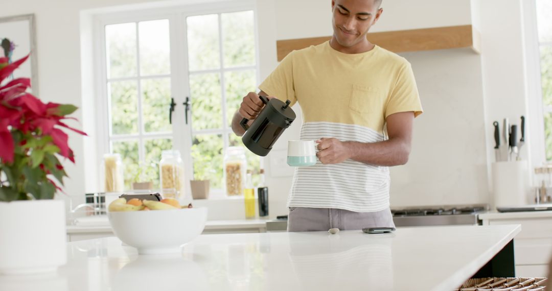 Young Man Pouring Coffee in Modern Kitchen at Home - Free Images, Stock Photos and Pictures on Pikwizard.com