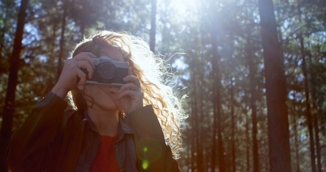 Woman Taking Photo With Vintage Camera in Forest - Free Images, Stock Photos and Pictures on Pikwizard.com