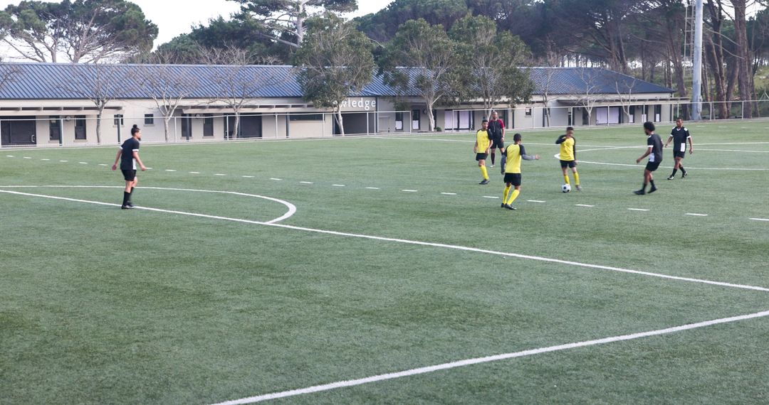 Youth Soccer Team Conducting Practice Session on Green Pitch