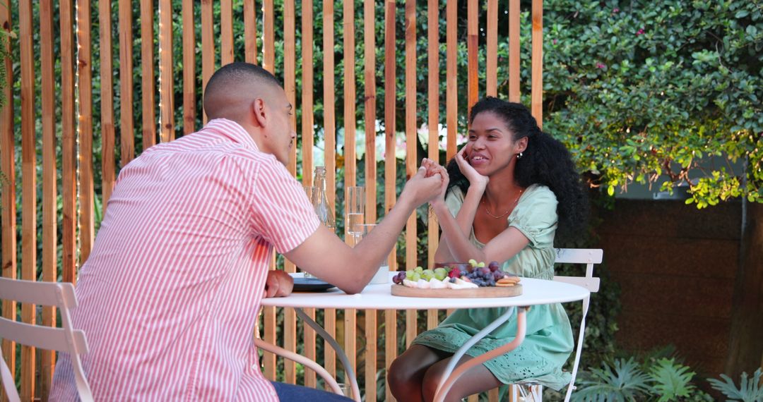 Couple Enjoys Cozy Garden Table Sharing Dessert and Conversation
