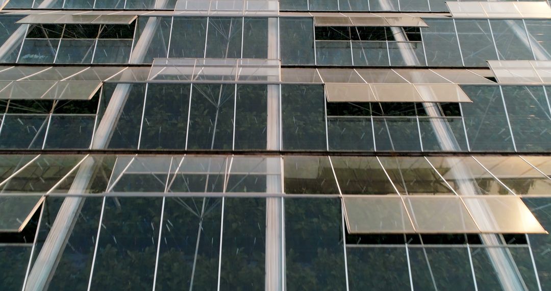 This photo captures the intricate beauty of urban architecture through reflective glass patterns. - Free Images, Stock Photos and Pictures on Pikwizard.com
