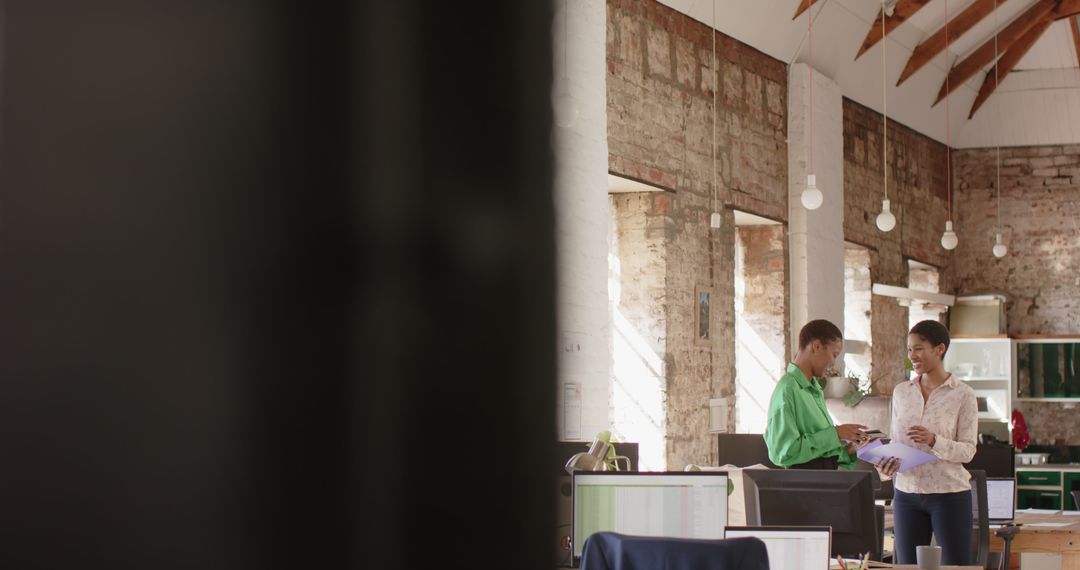 Business Professionals Discussing Documents in Modern Office Space