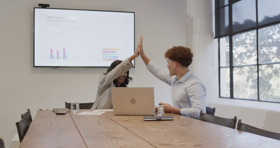 Diverse Colleagues Celebrate a Successful Meeting with High Five