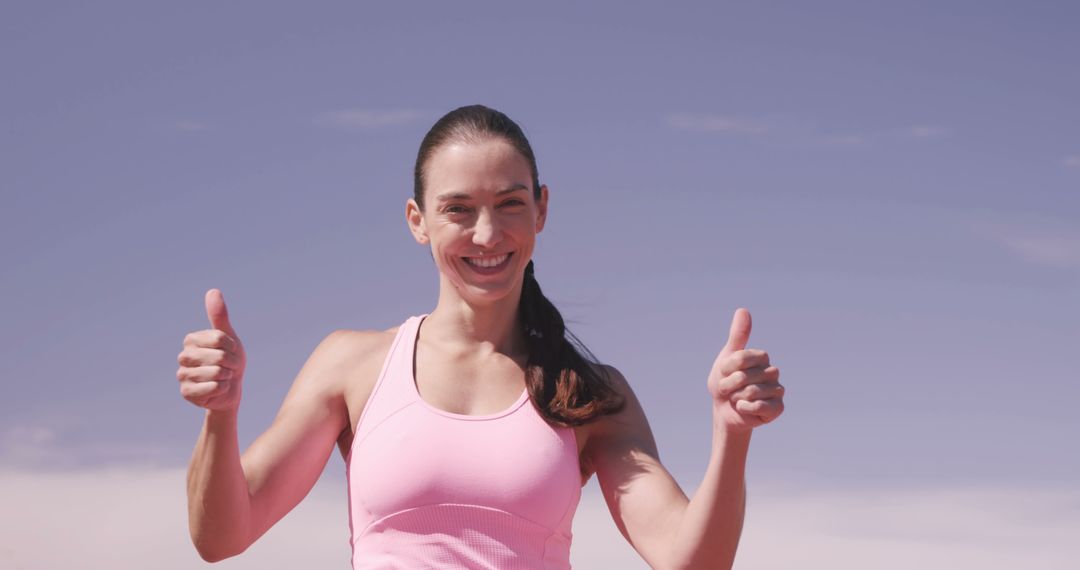 Young Woman Smiling and Giving Thumbs Up Outdoors - Free Images, Stock Photos and Pictures on Pikwizard.com