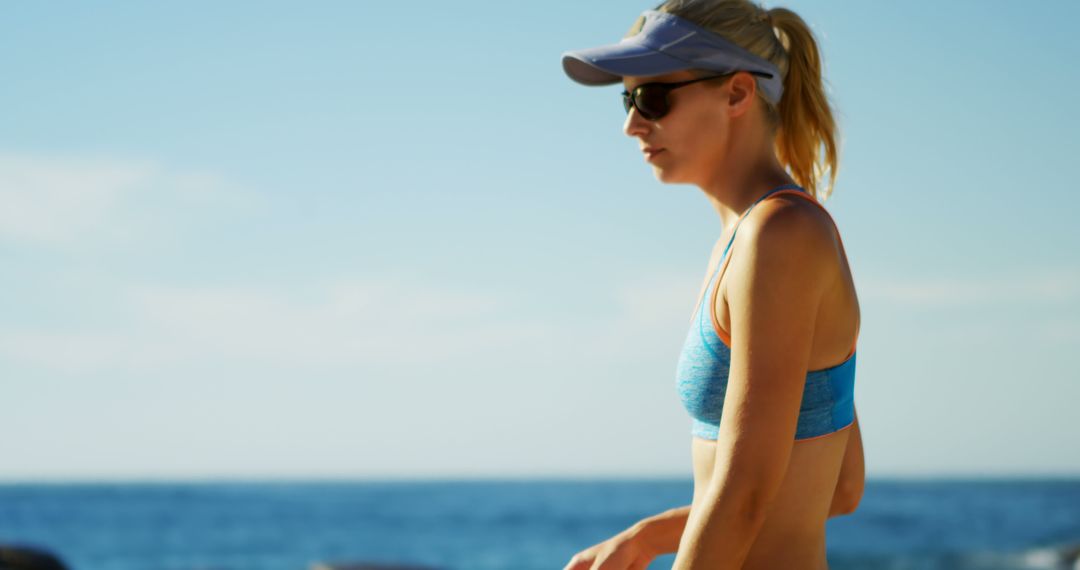 Fit Woman Running on Beach with Sunglasses and Cap - Free Images, Stock Photos and Pictures on Pikwizard.com