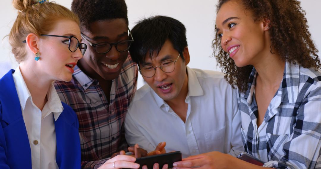 Young Diverse Business Team Engaging with Mobile Technology