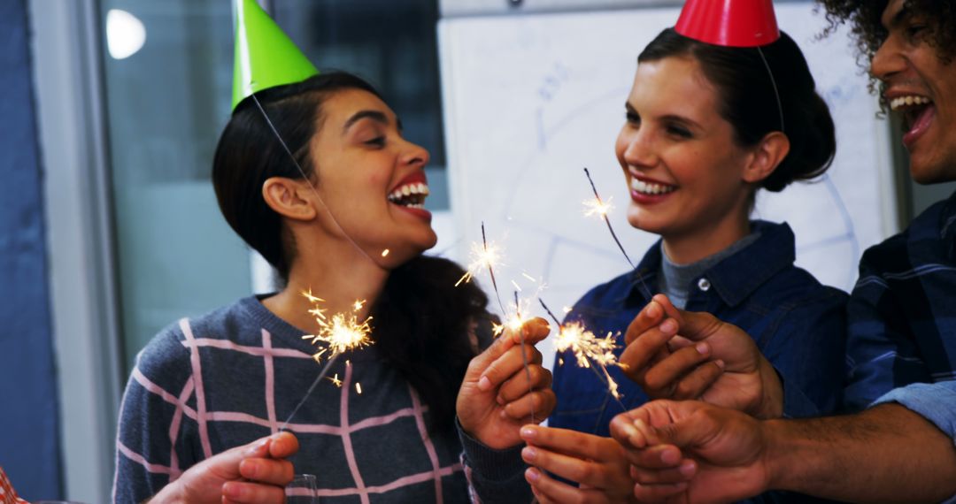 Team Celebrating Office Birthday with Happiness and Sparklers - Free Images, Stock Photos and Pictures on Pikwizard.com