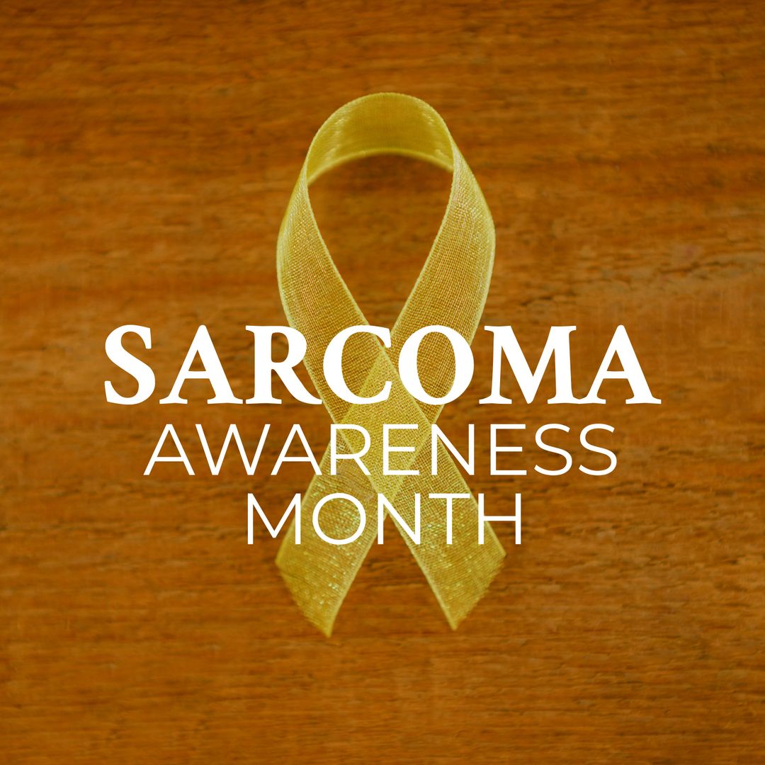Yellow Ribbon for Sarcoma Awareness Month on Wood Background