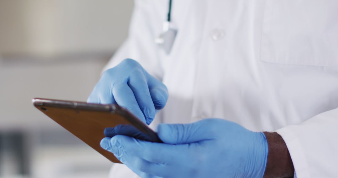 Doctor Using Smartphone with Protective Gloves in Medical Office - Free Images, Stock Photos and Pictures on Pikwizard.com