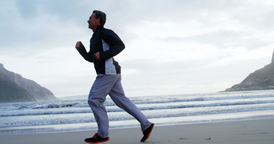 Man jogging on beach during morning - Free Images, Stock Photos and Pictures on Pikwizard.com