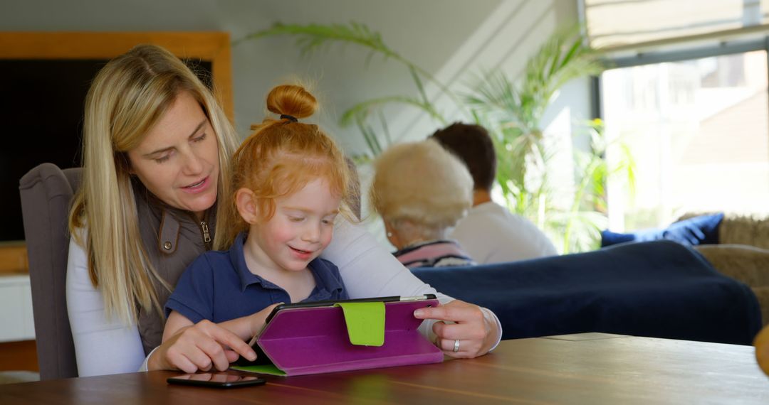 Mother Helping Daughter with Tablet at Home - Free Images, Stock Photos and Pictures on Pikwizard.com