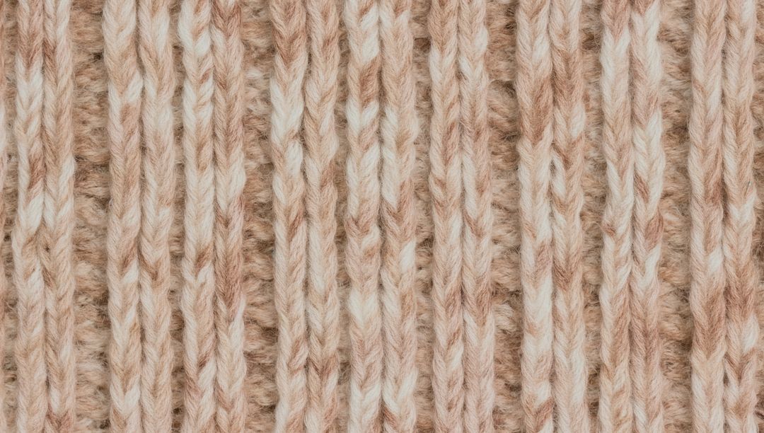 Displaying two-tone ribbed wool knit texture close-up, soft variegated yarn pattern