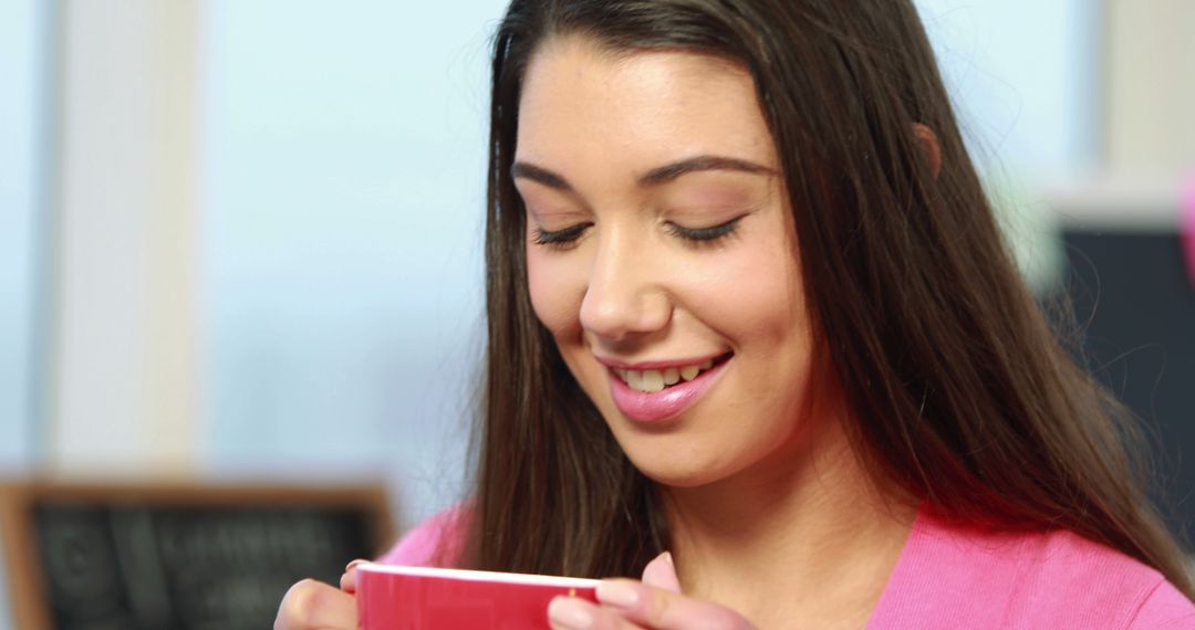 Smiling Young Woman Enjoying Hot Beverage - Free Images, Stock Photos and Pictures on Pikwizard.com