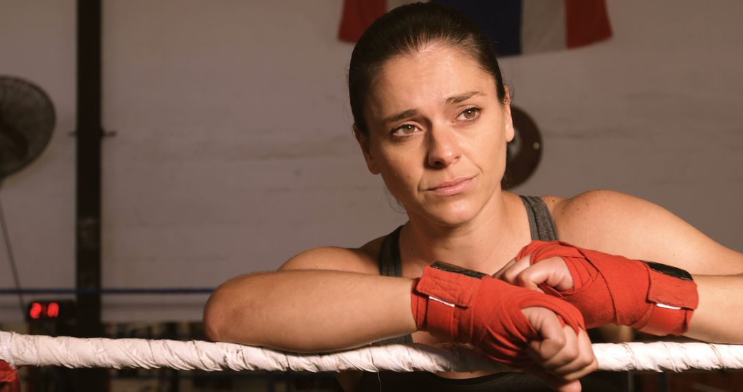 Tired Female Boxer Resting on Ring Ropes After Training - Free Images, Stock Photos and Pictures on Pikwizard.com