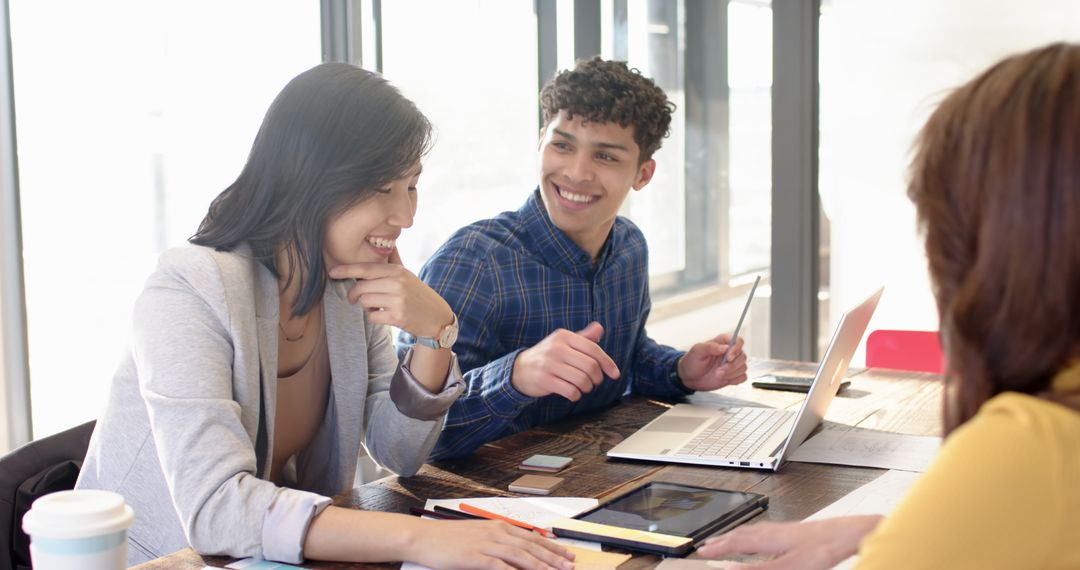 Diverse Coworkers Collaborating in Modern Office with Technology