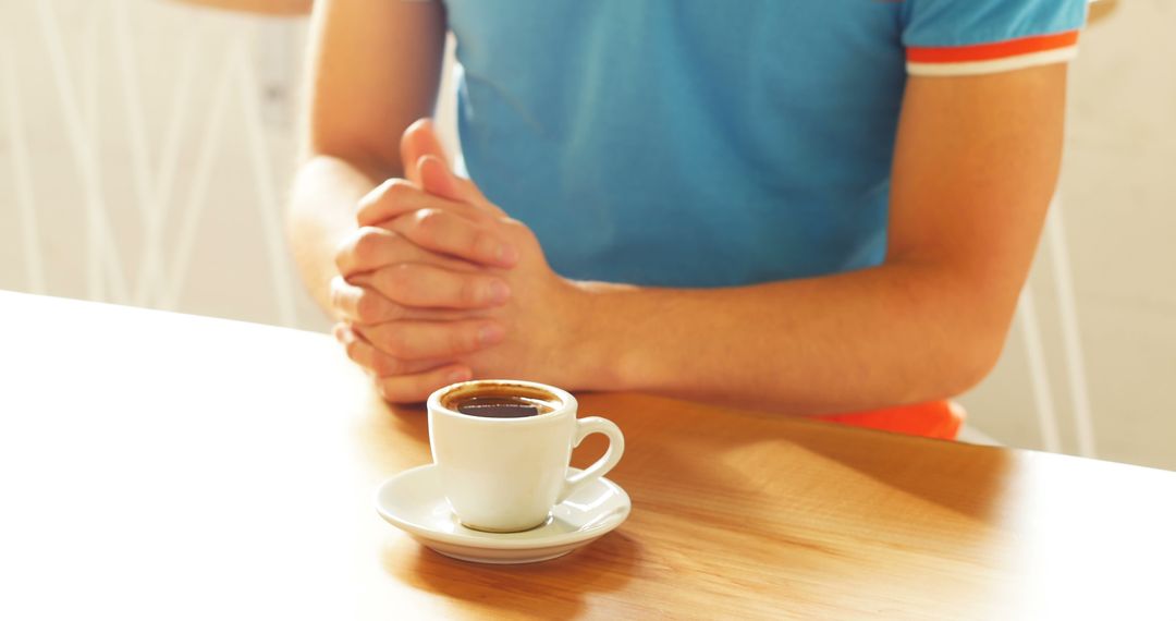 Man's Hands Resting on Table Near Espresso Cup - Free Images, Stock Photos and Pictures on Pikwizard.com