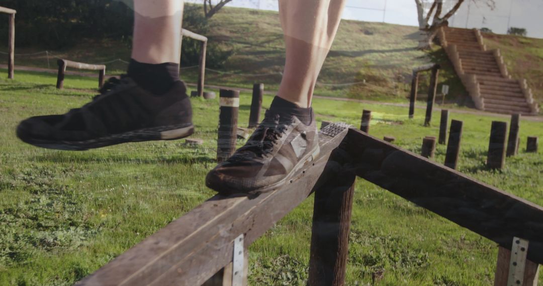 Athlete Balancing on Wooden Beam in Outdoor Obstacle Course