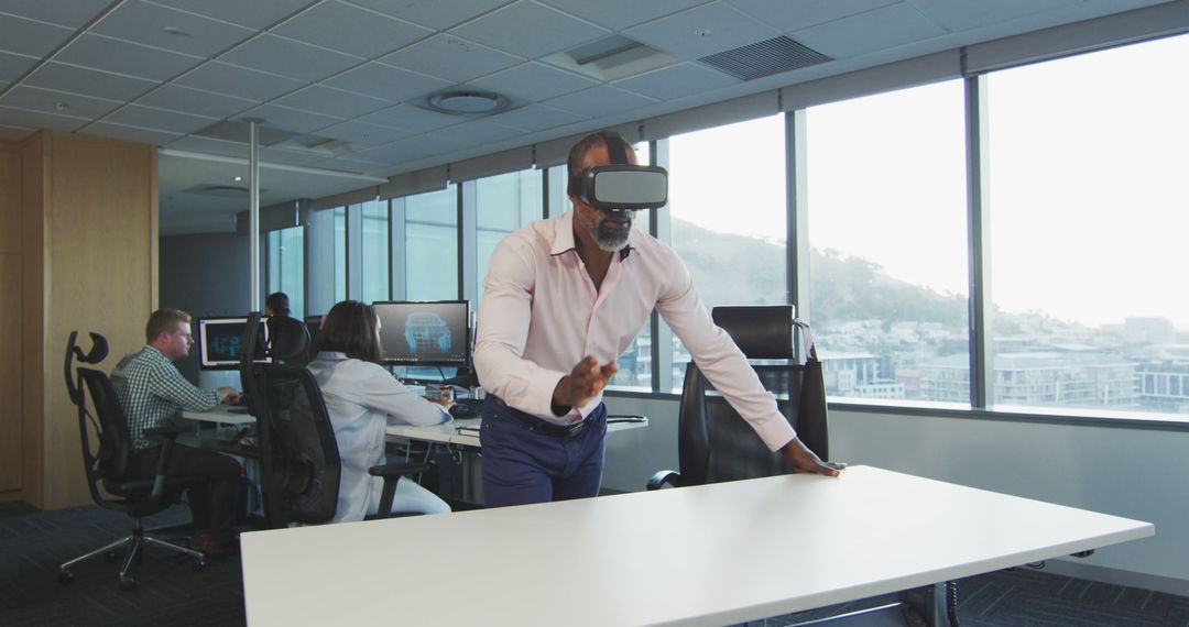 Man Using VR Headset in Modern Office Environment - Free Images, Stock Photos and Pictures on Pikwizard.com