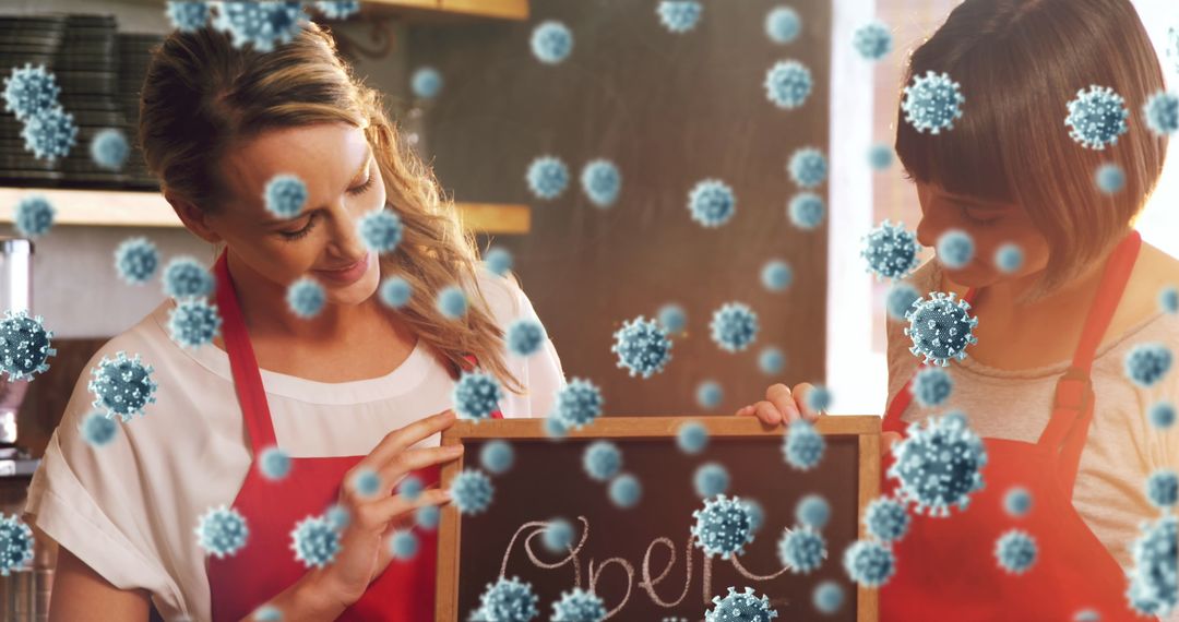 Two Women Holding Open Sign with Floating Virus Particles