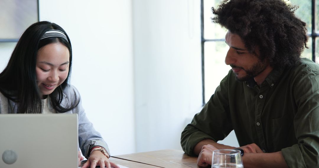 Diverse Business Colleagues Discussing Documents in Modern Office Meeting