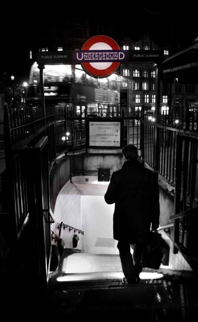 Man Descending London Underground Steps at Night with Red Bus in Background - Free Images, Stock Photos and Pictures on Pikwizard.com