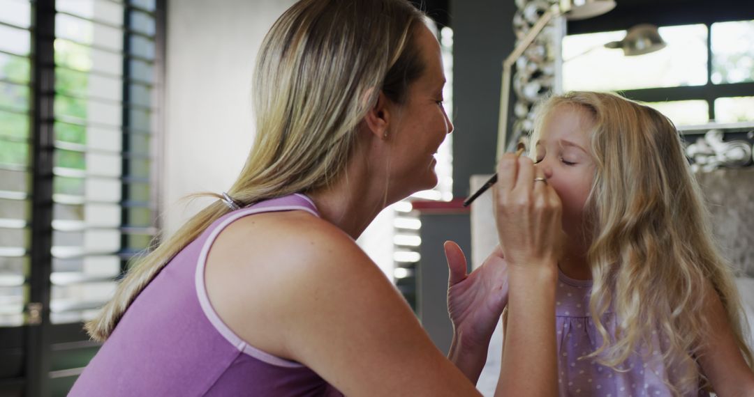 Mother Applying Makeup to Daughter in Bright Living Room - Free Images, Stock Photos and Pictures on Pikwizard.com