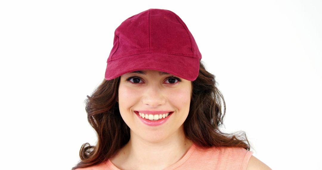 Smiling Woman Wearing Red Baseball Cap on White Background - Free Images, Stock Photos and Pictures on Pikwizard.com