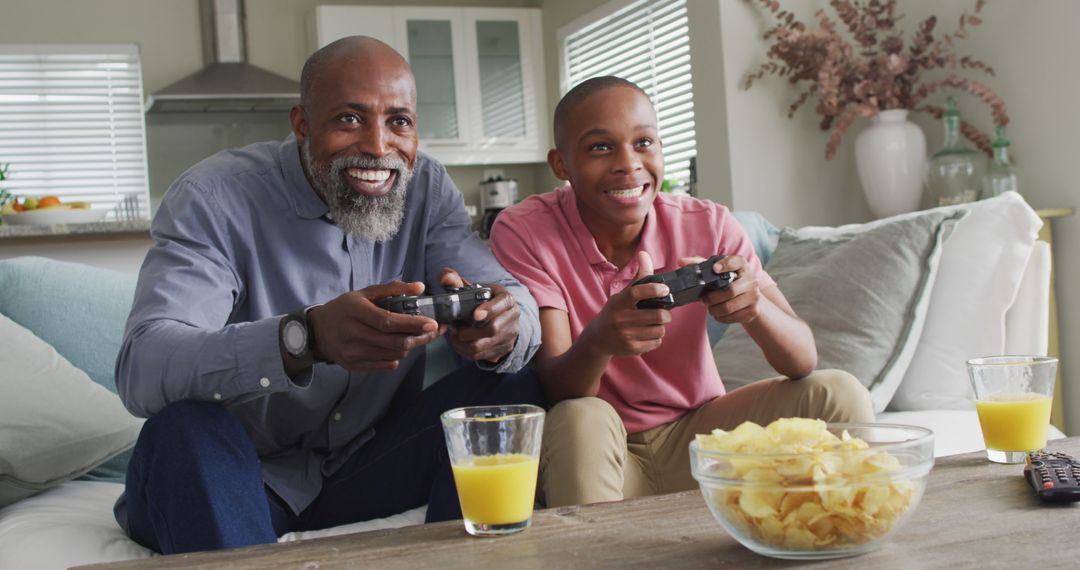 Image of happy african american father and son playing image games - Free Images, Stock Photos and Pictures on Pikwizard.com
