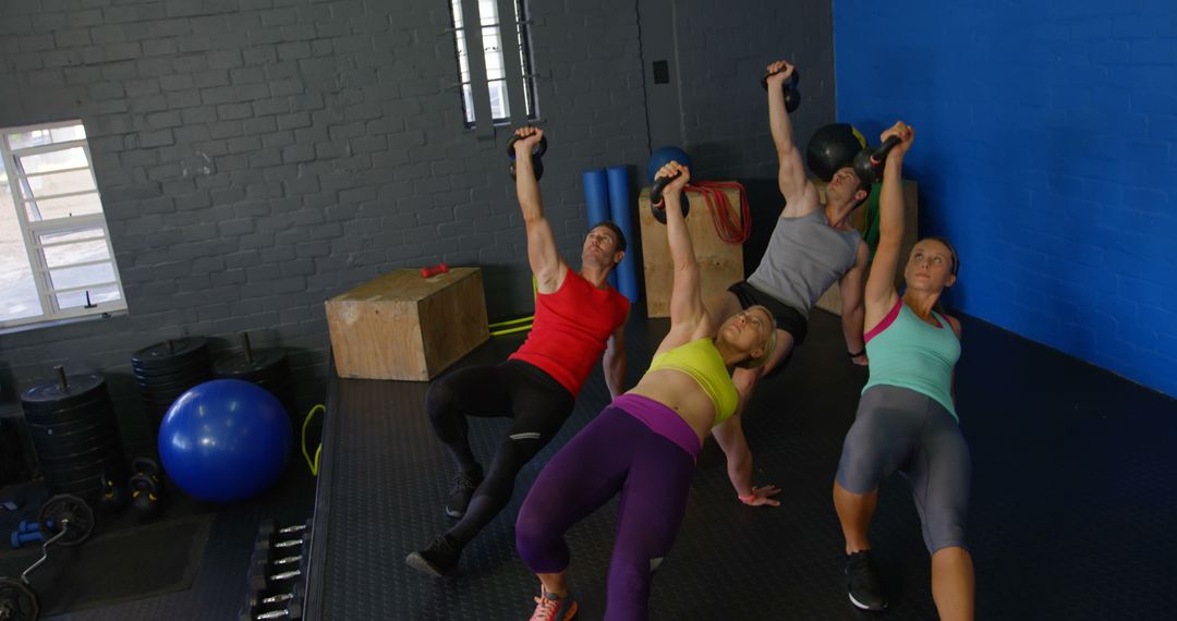 Group Exercise Class Holding Kettlebells in Fitness Studio - Free Images, Stock Photos and Pictures on Pikwizard.com