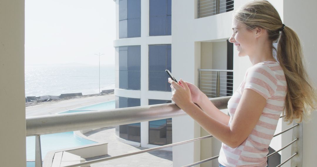 Young Woman Enjoying Ocean View While Texting on Smartphone - Free Images, Stock Photos and Pictures on Pikwizard.com
