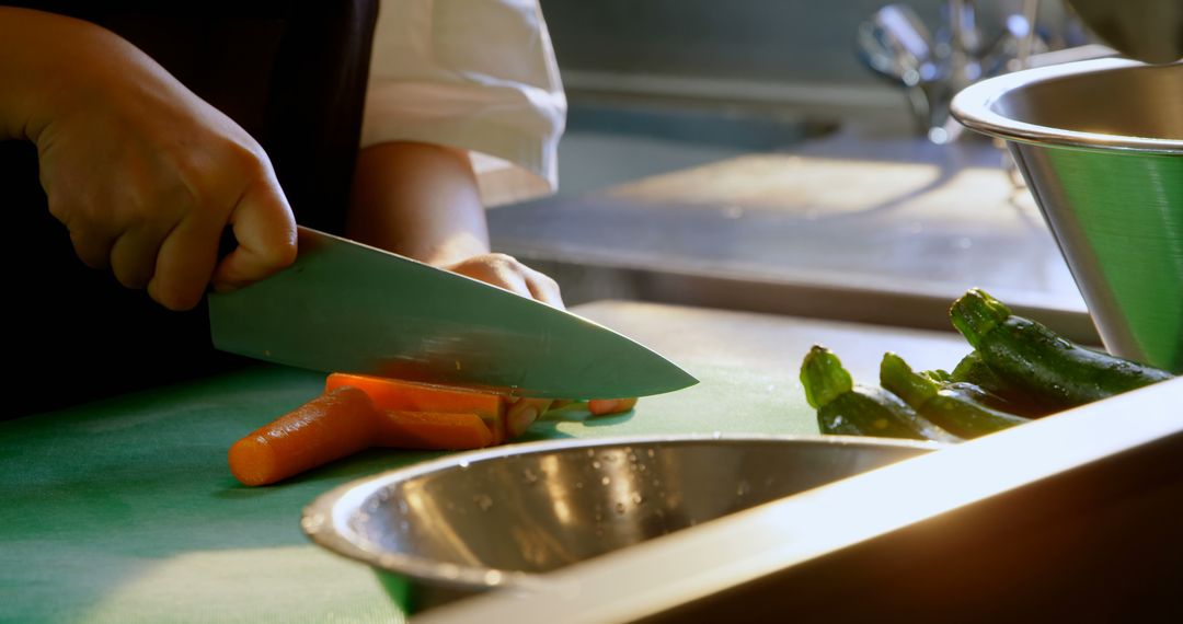 Chef Chopping Carrots in Professional Kitchen - Free Images, Stock Photos and Pictures on Pikwizard.com