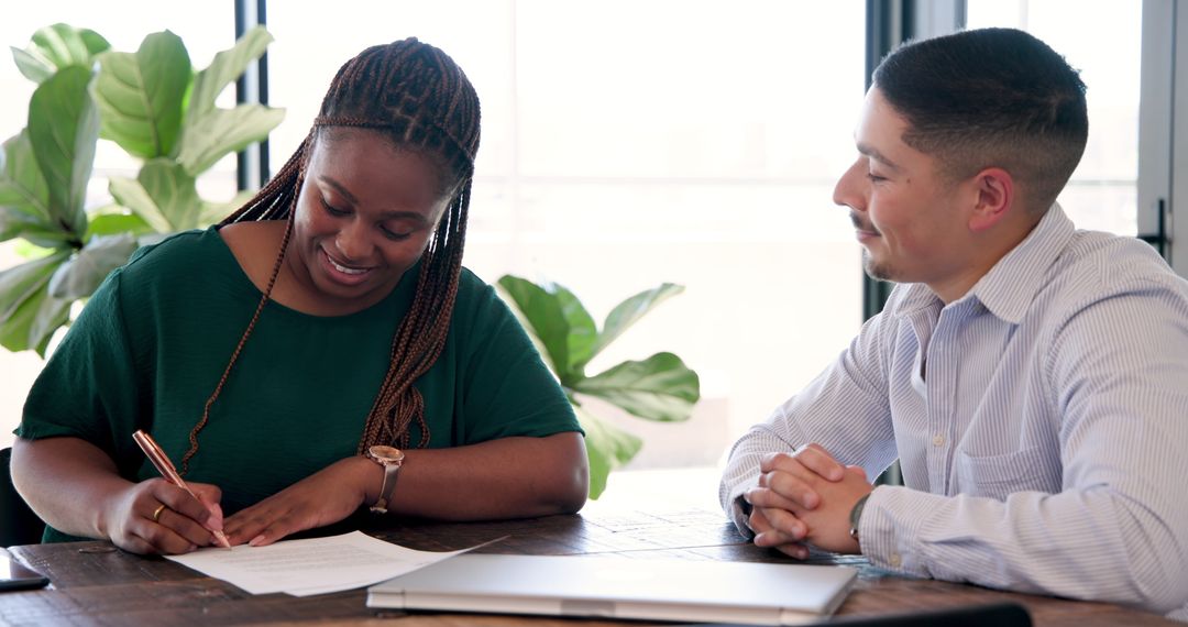 Colleagues Discussing Project Details in Office Space