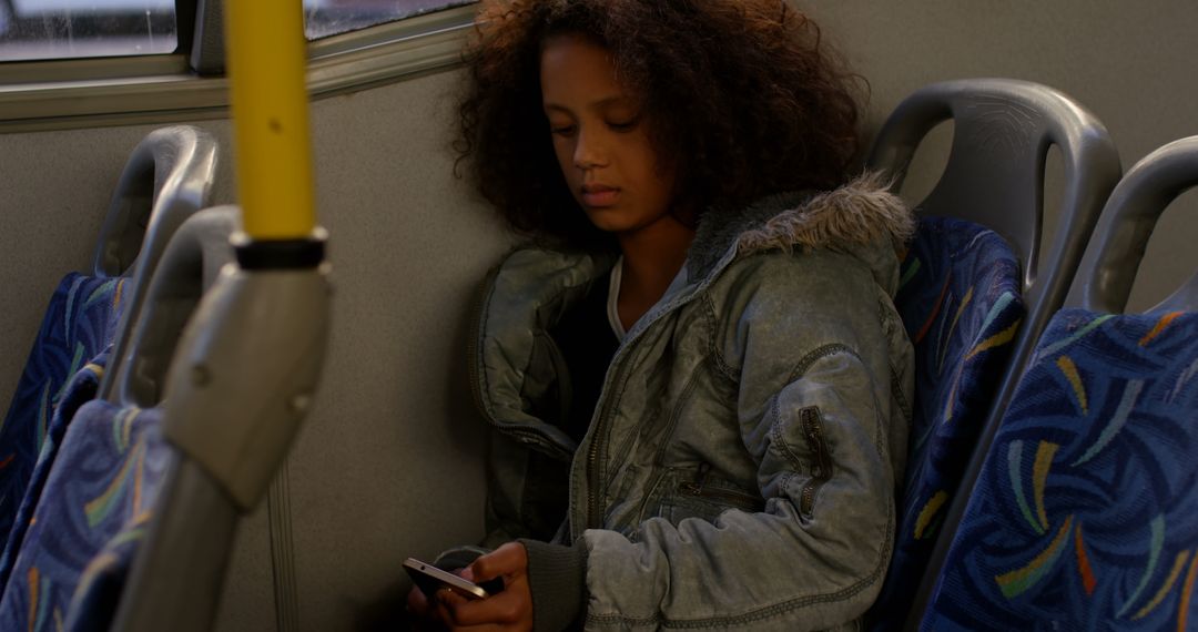 Girl Texting on Bus During Evening Commute