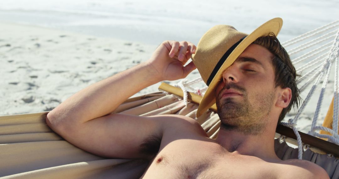 Relaxed Man Sleeping on Hammock at Sandy Beach - Free Images, Stock Photos and Pictures on Pikwizard.com