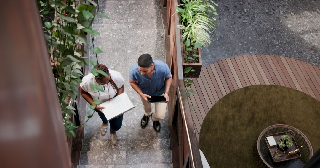 Colleagues Walking and Discussing Project in Eco-Friendly Office